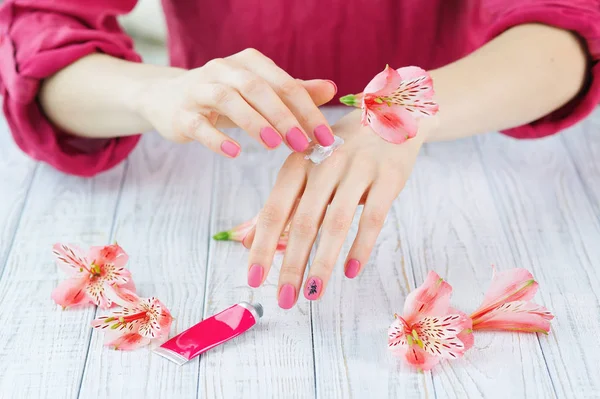 Mani donna con bella manicure rosa opaca — Foto Stock