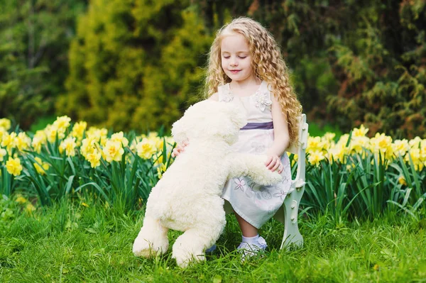 Happy little girl in blooming garden — Stock Photo, Image