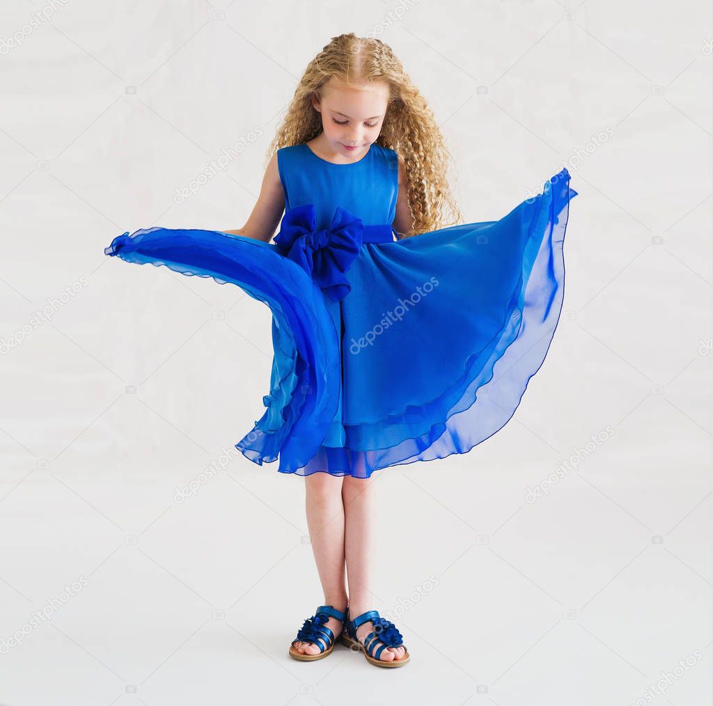 Beautiful little girl wearing trendy blue dress