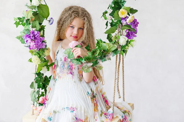 Beautiful girl on a flower swing — Stock Photo, Image