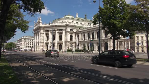 VIENNA, AUSTRIA- MAY 16: Ringstrasse is one of the main streets with The Burgtheater and red tram. Vienna is the number one city in the world in "Quality of Living" survey of hundreds of cities. — Stock Video