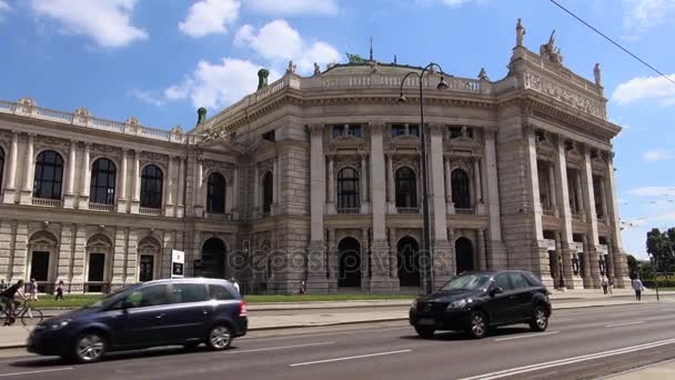 VIENNA, AUSTRIA- MAY 16: Ringstrasse is one of the main streets with The Burgtheater and red tram. Vienna is the number one city in the world in "Quality of Living" survey of hundreds of cities. — Stock Video