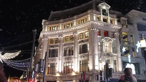 London - DEC 2016: Christmas lights and London buses at the station on busy Oxford Street London, England, United Kingdom in December, 2016. Oxford circus at traffic rush. — Stock Video