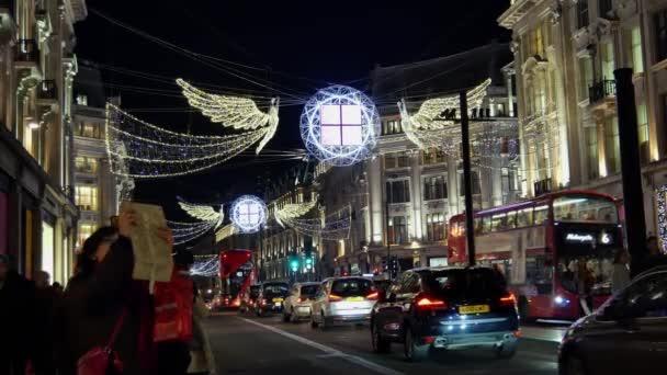 LONDRES - DEC 19: Christmas Lights Display on Regent Street on Dec 19, Londres, Reino Unido. As luzes de Natal coloridas modernas atraem e encorajam as pessoas para a rua . — Vídeo de Stock