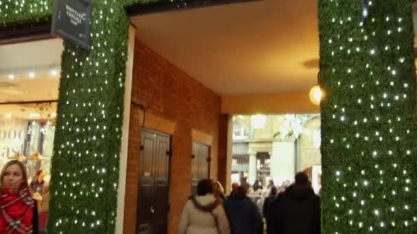 LONDRES, Reino Unido - DEZEMBRO 20, 2016: Os compradores apreciam as decorações de Natal no mercado Covent Garden, 4k Ultrahd — Vídeo de Stock