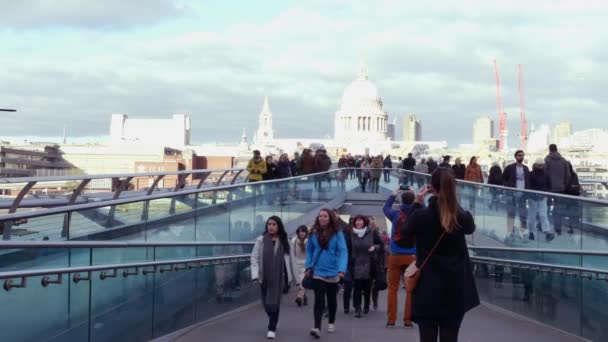 LONDRES, Reino Unido - 20 DE DEZEMBRO DE 2016: Pessoas caminhando sobre a ponte do Milênio. É uma ponte suspensa com um comprimento total de 370 metros (1.214 pés) e uma largura de 4 metros (13 pés) .ultra hd 4k, em tempo real . — Vídeo de Stock