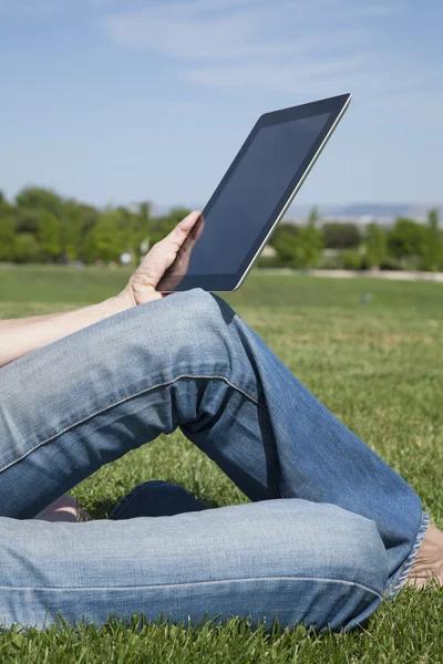 Tablet in jeans woman hands — Stock Photo, Image