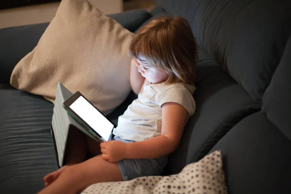 blank screen tablet and child sitting in sofa watching