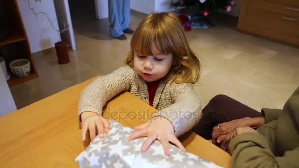 Child opening Christmas present with grandmother — Stock Video