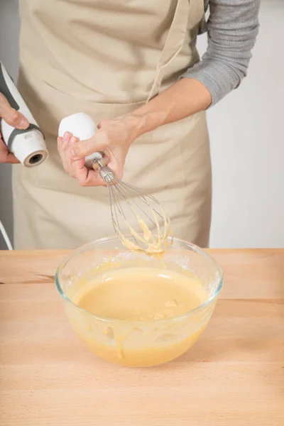 detail of woman finishing to whip cream with electric mixer