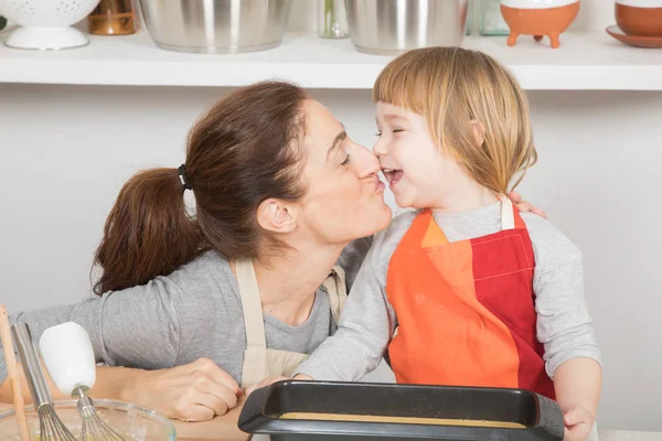 Tender and happy mother and child when finishing cake — Stock Photo, Image