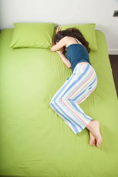 Woman sleeping hiding face under arm — Stock Photo, Image