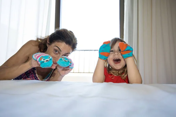 Child and mother playing with socks in their hands — Stock Photo, Image