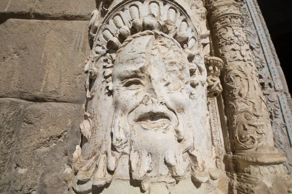 Ancient face sculpture on facade Museum of Santa Cruz in Toledo — Stock Photo, Image