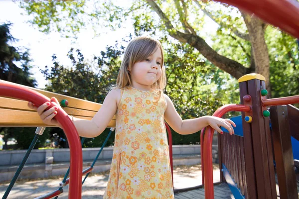 Thoughtful little girl playing in playground — Stock Photo, Image