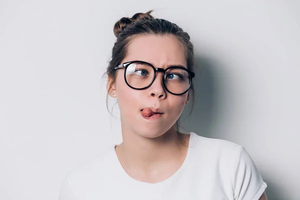 Close up indoor fashion lifestyle portrait of cool pretty young brunette girl, amazing, cute face, image with flash. making crazy funny grimace in glasses