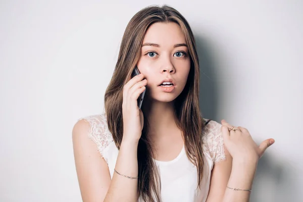 Young woman talking on phone in office — Stock Photo, Image