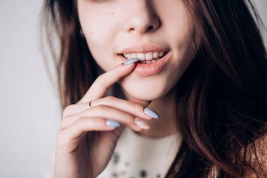 Seksi kadının doğal dudaklar ve güzel manikür ile kapatın. Gülümseme, duygu