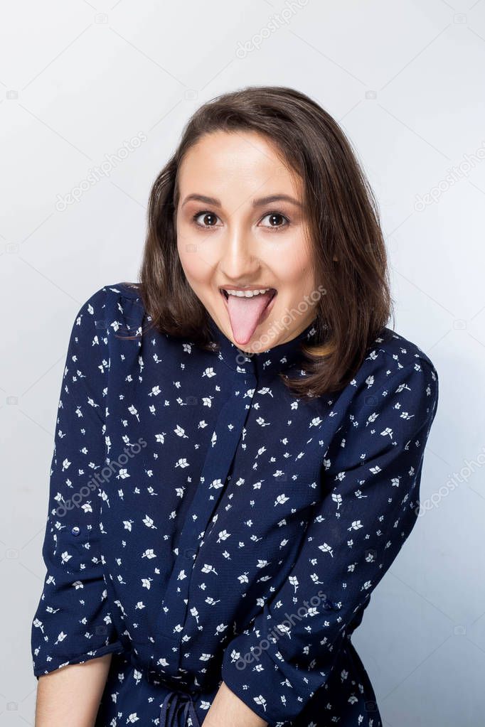 Woman showing tongue, laughing, smiling. Human emotions, reactions, feelings