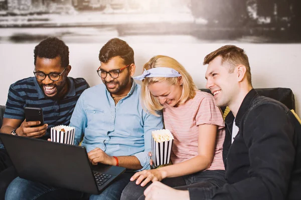 Un grupo de amigos usando el portátil y riendo — Foto de Stock