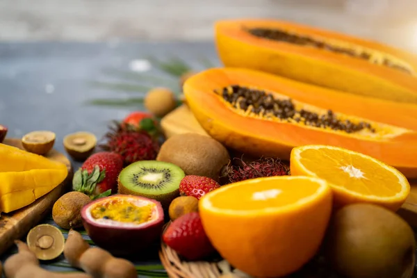 Exotic fruits on wooden chopping board