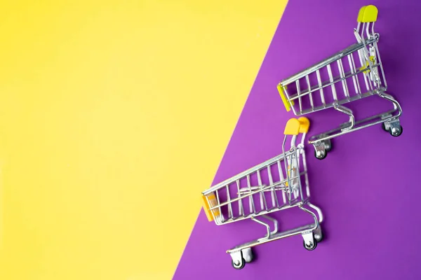 Shopping trolley on colorful background — Stock Photo, Image