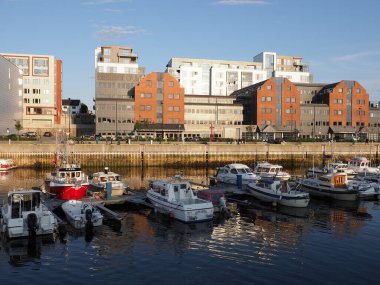 BODO, NORWAY on JULY 2019: Nordic cityscape and promenade with yachts and boats in european city at Salten region with clear blue sky in warm sunny summer day at sun set.