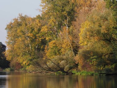 Great landscapes of trees and lake at Wilanow park in european Warsaw capital city in Poland, clear blue sky in 2018 warm sunny autumn day on October.