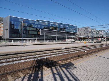 Glass modern building and platforms seen from central station in european capital city of Oslo at Ostlandet district in Norway, clear blue sky in 2019 warm sunny summer day on July.