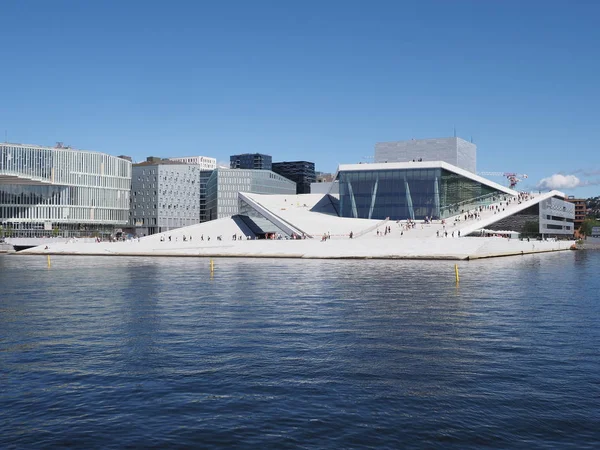 Panoramic view to european capital city of Oslo reflected in water at Ostlandet district in Norway, clear blue sky in 2019 warm sunny summer day on July.