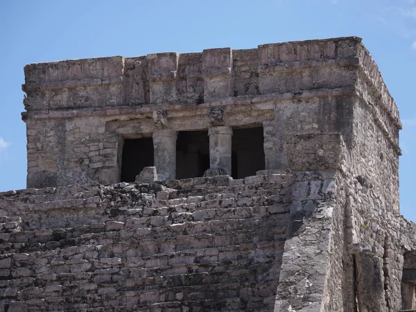 Temple of god of winds in mexican city of Tulum at Quintana Roo in Mexico on grassy field, cloudy blue sky in 2018 warm sunny winter day on March.