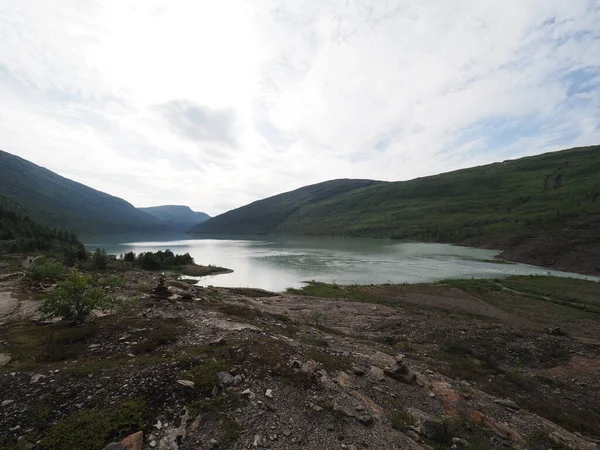 Wonderful Svartisvatnet lake landscapes near european Svartisen glacier in Nordland county in Norway, cloudy sky in 2019 cold summer day on July.