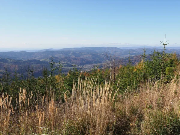 Desolate Silesian Beskids Mountains land near Salmopol pass view above european city of Szczyrk in Poland, clear blue sky in 2019 warm sunny autumn day in October.