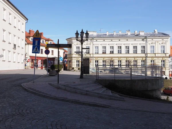 BIELSKO-BIALA, POLAND on February 2019: Buildings on St. Nicholas square in historical part of european city center seen from street with clear blue sky in warm sunny winter morning day.