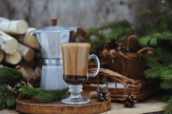 Coffee pot and a cup of coffee on the table with Christmas decorations — Stock Photo, Image