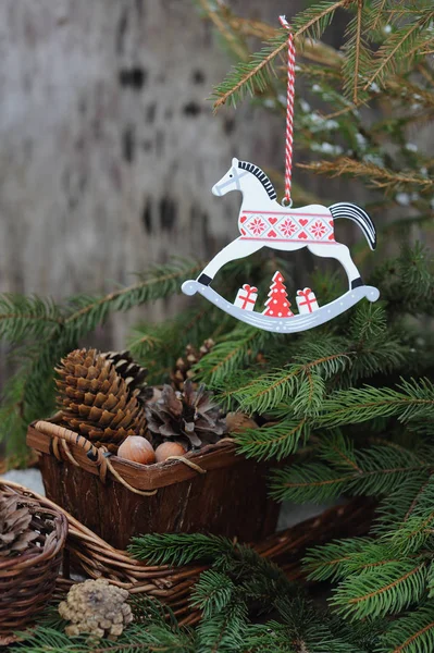 New Year toy of horse on tree with Christmas decorations — Stock Photo, Image