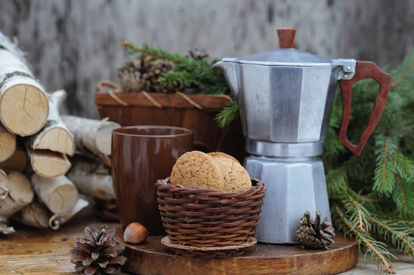 Vintage coffee maker pot with coffee and basket with cookies on holiday wooden table — Stock Photo, Image