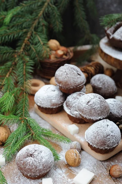 Chocolate muffin with sugar powder and holiday decorations — Stock Photo, Image