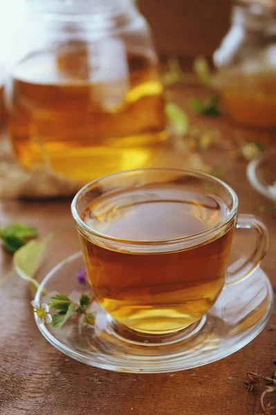 Cups of herbal tea with herbal flowers and strawberries — Stock Photo, Image