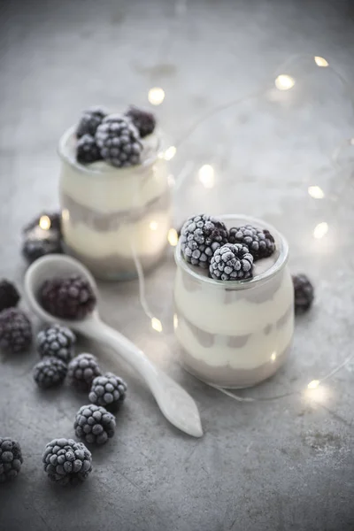 winter milk dessert with frozen blackberry