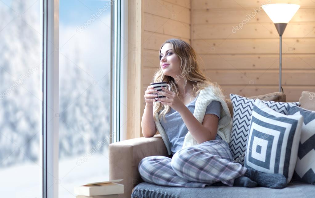 Young beautiful blonde woman with cup of coffee 