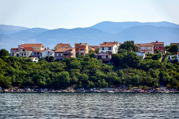 Barna tetős házak egy dombon fákkal, az Adria közelében — Stock Fotó