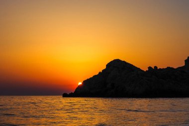 Günbatımı, sarı-turuncu gökyüzü.