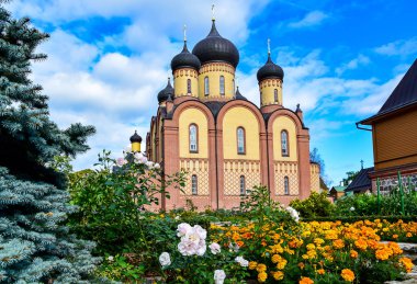 Siyah kubbeli kırmızı ve sarı tuğlalı bir kilise.