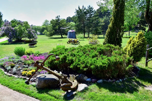 A monument of rusty anchors and stone.