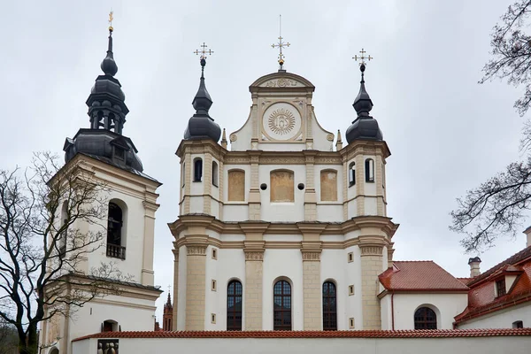 stock image Vilnius, Lithuania - Church of St. Michael, a white-beige building, with transitional features from Gothic to the Renaissance, now it houses the Museum of Church Heritage, in the winter afternoon.