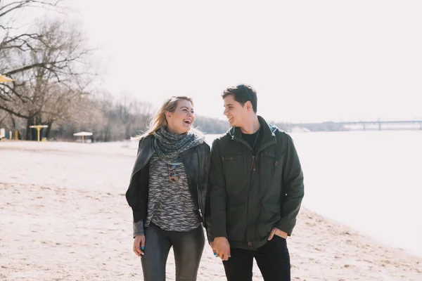 Cheerful loving each other couple kisses. Walk on the river bank and embrace — Stock Photo, Image