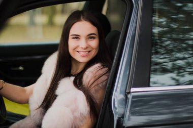 Çok güzel bir kız bir arabada Kürk giymiş bir ormandaki portresi