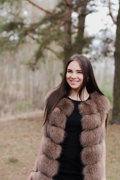 Portrait of a very beautiful girl in a forest dressed in fur — Stock Photo, Image