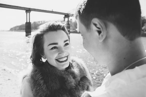 Happy couple in love hugging and sharing emotions, holding hands on the river bank — Stock Photo, Image